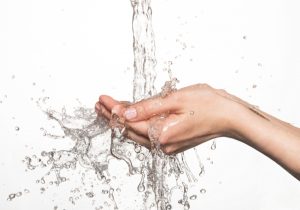 fresh-clear-water-splashing-into-a-person's-hand